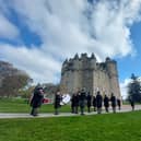 Drums & Pipes of The Gordon Highlanders Association Pipe Band lead the procession to Castle Fraser (NTS)