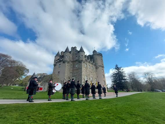 Drums & Pipes of The Gordon Highlanders Association Pipe Band lead the procession to Castle Fraser (NTS)