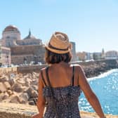 A young tourist looking at the coast of the city of Cadiz and the Cathedral, in Andalusia. Picture: Getty Images