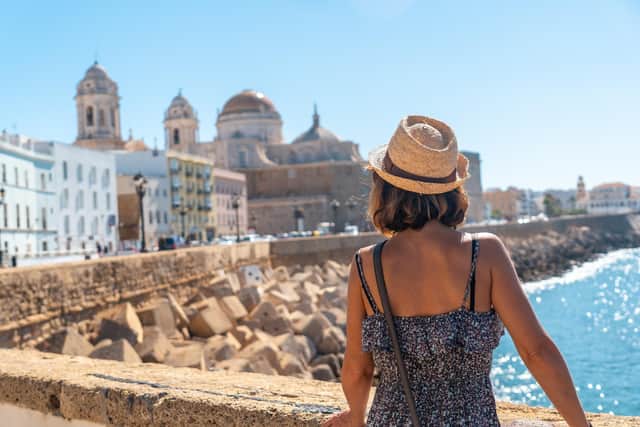 A young tourist looking at the coast of the city of Cadiz and the Cathedral, in Andalusia. Picture: Getty Images