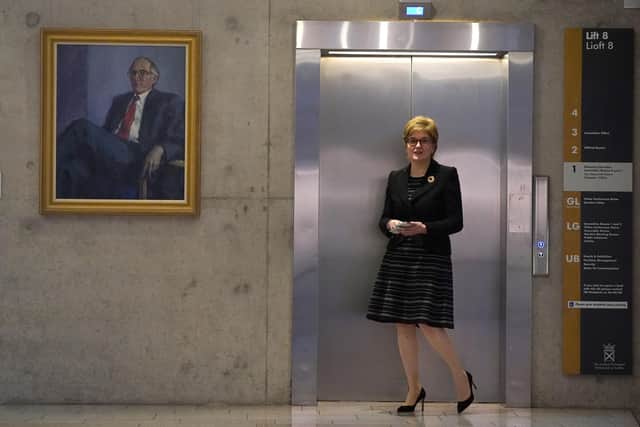 First Minister Nicola Sturgeon waits on a lift at the Scottish Parliament in Edinburgh