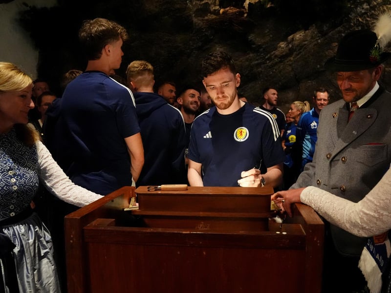 Scotland captain Andy Robertson signs the guest book as the team arrive at Bayernhalle in Garmisch-Partenkirchen, Germany, for a reception hosted by the Mayor.