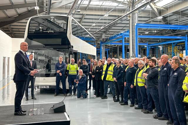 First Minister John Swinney speaking to Alexander Dennis team members in Larbert last year.