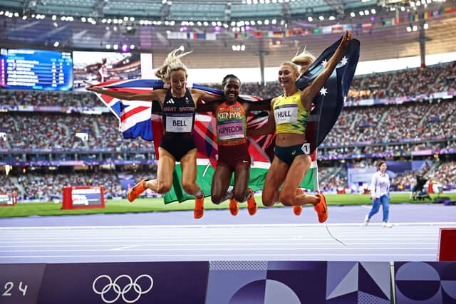 Bronze medallist Britain's Georgia Bell, gold medallist Kenya's Faith Kipyegon and silver medallist Australia's Jessica Hull celebrate after competing in the women's 1500m final of the athletics event at the Paris 2024 Olympic Games. (Photo by ANNE-CHRISTINE POUJOULAT/AFP via Getty Images)