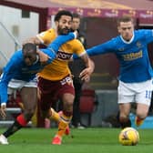 Motherwell's Jordan Roberts (centre) is challenged by Rangers' Glen Kamara and Steven Davis.