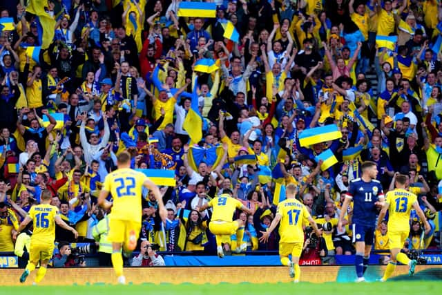 Ukraine's Roman Yaremchuk (centre) celebrates in front of the fans after scoring their side's second goal of the game against Scotland.