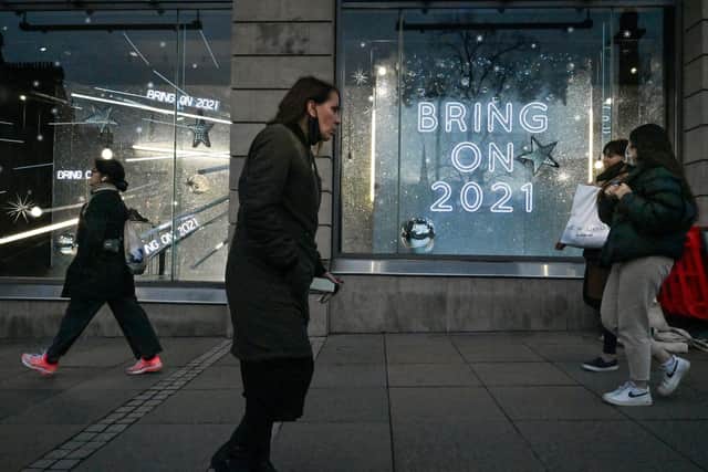 Members of the public walk past a window display at Harvey Nichols on November 11, 2020 in Edinburgh, Scotland. Picture: Jeff J Mitchell/Getty Images