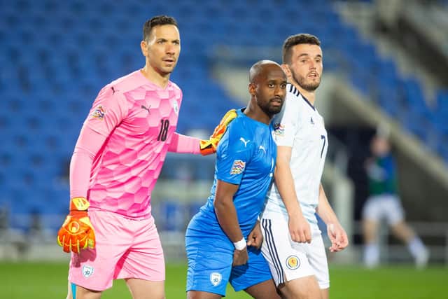 Ofir Marciano and Eli Dasa of Israel challenge John McGinn of Scotland during the UEFA Nations League group stage match between Israel and Scotland at Netanya Stadium on November 18, 2020 in Netanya, Israel. (Photo by Lior Mizrahi/Getty Images)