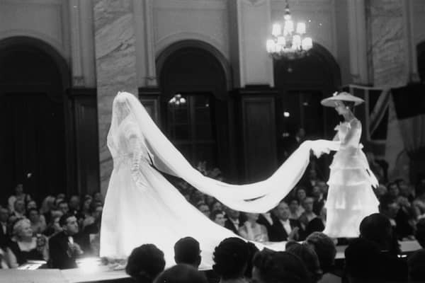 Models on the catwalk during French couturier Christian Dior's 1955 fashion show at the Central Hotel, Glasgow, Scotland. The designer flew eight models, six staff and 172 dresses to Scotland for two shows, one in Glasgow and one at the Gleneagles Hotel in Perthshire, to raise money for the Friends of France, an organisation, which organises exchange visits for Scottish and French school children. Original publication: Picture Post Scottish edition - 7765 - Dior In Scotland - published, 21st May 1955. (Photo by Thurston Hopkins/Picture Post/Hulton Archive/Getty Images)