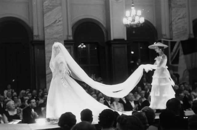 Models on the catwalk during French couturier Christian Dior's 1955 fashion show at the Central Hotel, Glasgow, Scotland. The designer flew eight models, six staff and 172 dresses to Scotland for two shows, one in Glasgow and one at the Gleneagles Hotel in Perthshire, to raise money for the Friends of France, an organisation, which organises exchange visits for Scottish and French school children. Original publication: Picture Post Scottish edition - 7765 - Dior In Scotland - published, 21st May 1955. (Photo by Thurston Hopkins/Picture Post/Hulton Archive/Getty Images)