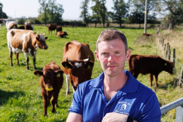 Bryce Cunningham, farmer and owner of Mossgiel Organic Farm near Mauchline is pictured in a field with some of his herd of Ayrshire cows.