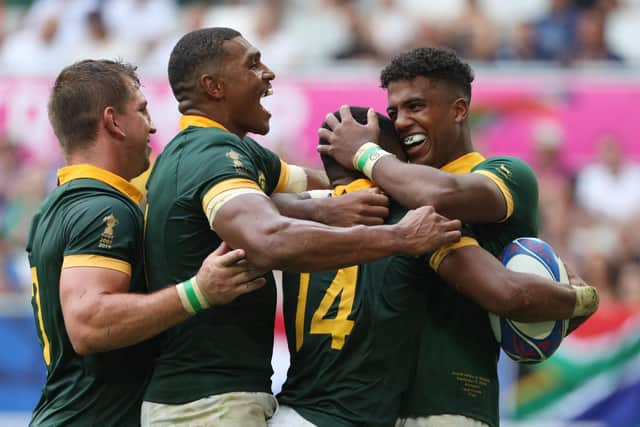 South Africa's Grant Williams (second right) celebrates with teammates after scoring the team's seventh try in the win over Romania. (Photo by ROMAIN PERROCHEAU/AFP via Getty Images)