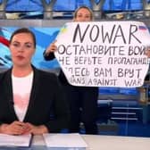 This video grab taken on March 15, 2022 shows Russian Channel One editor Marina Ovsyannikova holds a poster reading " Stop the war. Don't believe the propaganda. Here they are lying to you"  during on-air TV studio by news anchor Yekaterina Andreyeva , Russia's most-watched evening news broadcast, in Moscow on March 14, 2022 .Photo: AFP PHOTO / Channel One.