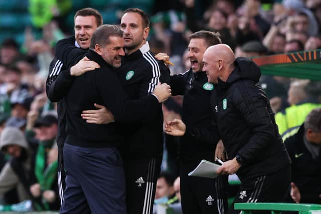 Ange Postecoglou celebrates with his Celtic backroom staff after victory over Ferencvaros.