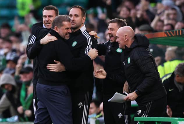 Ange Postecoglou celebrates with his Celtic backroom staff after victory over Ferencvaros.