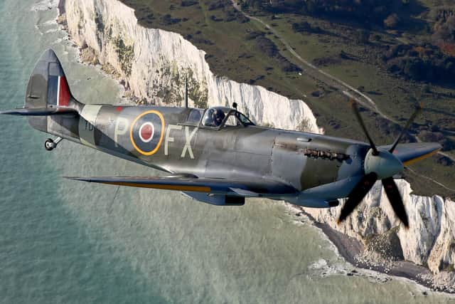 A World War II Spitfire, flies over the White Cliffs of Dover in Kent (Picture: Gareth Fuller/PA)