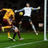 Motherwell's Ricki Lamie heads past Craig Gordon in the 2-0 win over Hearts.  (Photo by Craig Foy / SNS Group)