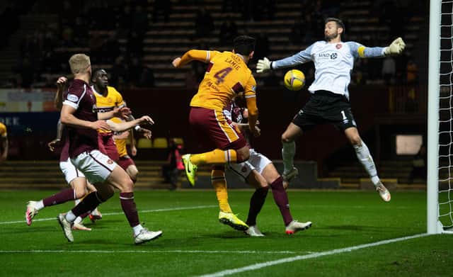 Motherwell's Ricki Lamie heads past Craig Gordon in the 2-0 win over Hearts. (Photo by Craig Foy / SNS Group)