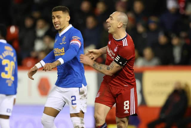 Aberdeen's Scott Brown (right) speaks to Rangers' James Tavernier during a match in 2022.