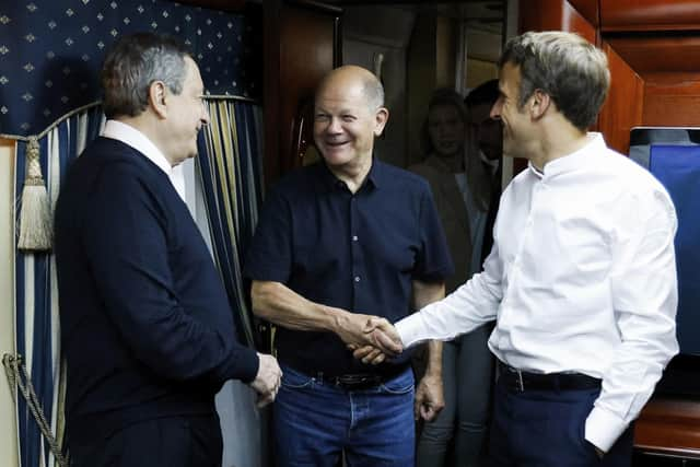 French President Emmanuel Macron, right, German Chancellor Olaf Scholz, center, and Italian Prime Minister Mario Draghi travel on board a train bound to Kyiv after departing from Poland Thursday, June 16, 2022. The Europeans leaders are expected to meet with Ukraine's President Volodymyr Zelenskyy as they prepare for a key European Union leaders' summit in Brussels next week and a June 29-30 NATO summit in Madrid.(Ludovic Marin, Pool via AP)