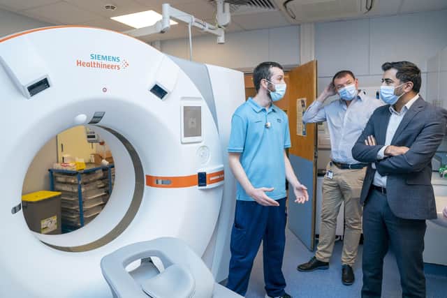 Health secretary Humza Yousaf with radiographer Steven Townsend (left) and medical director Chris McKenna (centre) in the CT suite during a visit to the Rapid Cancer Diagnostic Service (RCDS) at the NHS Fife Victoria Hospital in Kirkcaldy. Picture: Jane Barlow/PA Wire