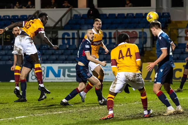 Bevis Mugabi heads home Motherwell's winner against Ross County.