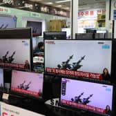 TV screens show a news program reporting about North Korea's ballistic missiles. The missiles fell into the Sea of Japan on Thursday, March 25.