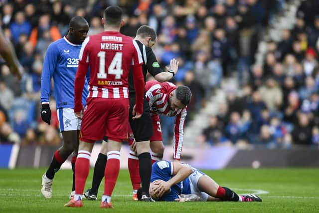 Rangers' Ryan Jack goes down with an injury after the challenge that earned St Johnstone's Nicky Clark a red card. (Photo by Rob Casey / SNS Group)