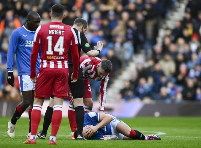Rangers' Ryan Jack goes down with an injury after the challenge that earned St Johnstone's Nicky Clark a red card.  (Photo by Rob Casey / SNS Group)