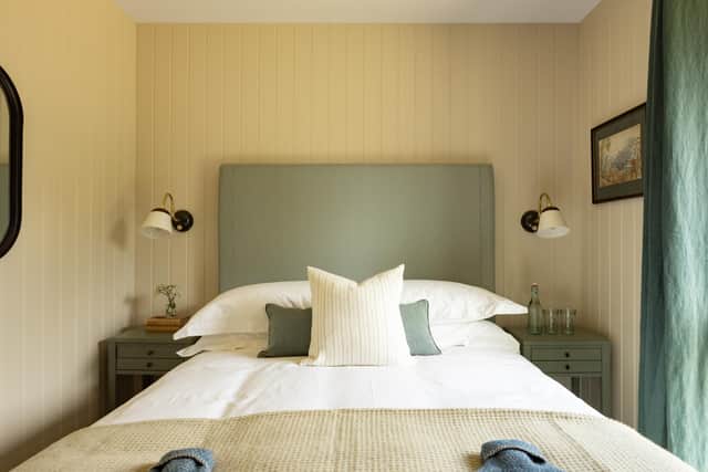 A bedroom in one of the cabins where the decor is muted and pleasing, with fittings a mixture of high modern and rustic and warm touches such as real wool blankets, tweed cushions and hot water bottles. Pic: Alexander Baxter