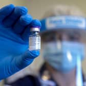 An NHS worker holds up a vial of the Pfizer-Biontech Covid-19 vaccine (Photo: CHRIS JACKSON/POOL/AFP via Getty Images)