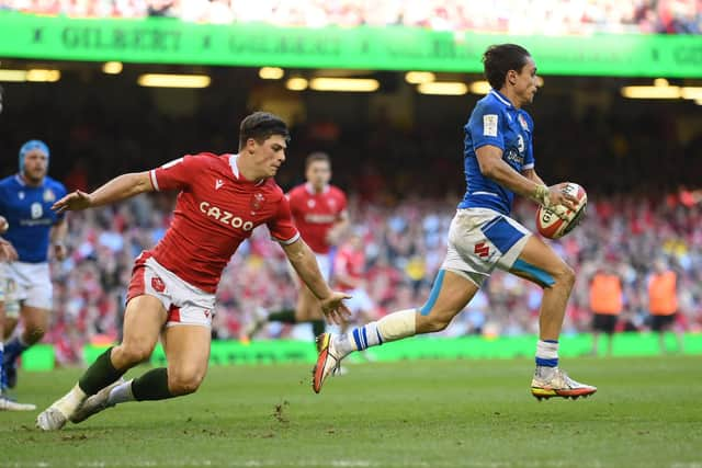 Italy's dazzling full-back Ange Capuozzo leaves Louis Rees-Zammit of Wales in his wake. (Photo by Mike Hewitt/Getty Images)