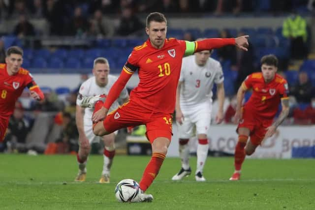 Wales' midfielder Aaron Ramsey scores their third goal from the penalty spot during the FIFA World Cup 2022 Group E qualifier football match between Wales and Belarus at Cardiff City Stadium. (Photo by Geoff Caddick / AFP) (Photo by GEOFF CADDICK/AFP via Getty Images)