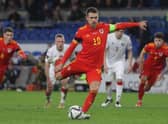 Wales' midfielder Aaron Ramsey scores their third goal from the penalty spot during the FIFA World Cup 2022 Group E qualifier football match between Wales and Belarus at Cardiff City Stadium. (Photo by Geoff Caddick / AFP) (Photo by GEOFF CADDICK/AFP via Getty Images)