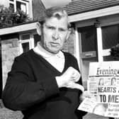 Holding a copy of the Evening News newspaper, Eddie Turnbull, former manager of Hibernian football club, gives the 'thumbs down' to Wallace Mercer's proposed Hearts & Hibs merger in 1990.