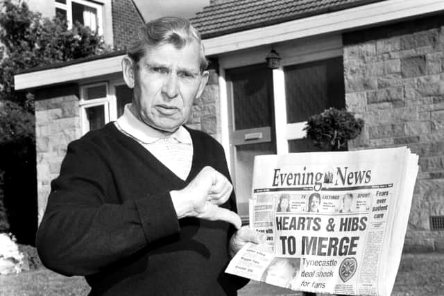 Holding a copy of the Evening News newspaper, Eddie Turnbull, former manager of Hibernian football club, gives the 'thumbs down' to Wallace Mercer's proposed Hearts & Hibs merger in 1990.
