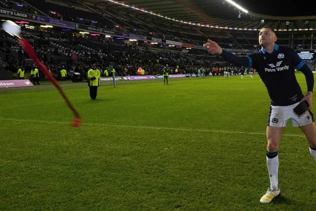 Finn Russell hands over his man of the match medal. (Photo by Ross MacDonald / SNS Group)