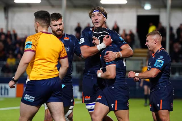 Darcy Graham get a hug from Edinburgh's new co-captain, Jamie Ritchie. (Photo by Simon Wootton / SNS Group)