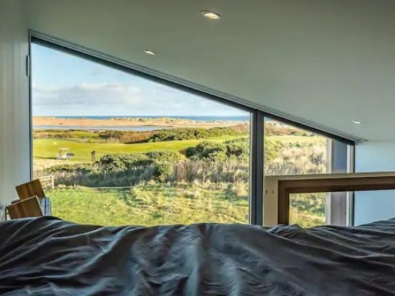 The bedroom has incredible views over the coast.