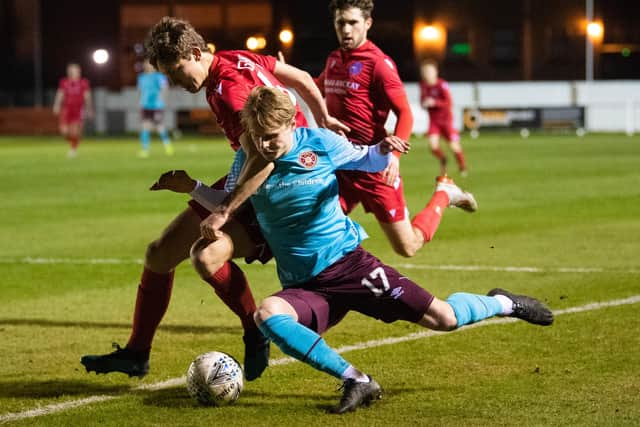 Brora's Dale Gillespie challanges Gary Mackay-Steven of Hearts at Dudgeon Park.