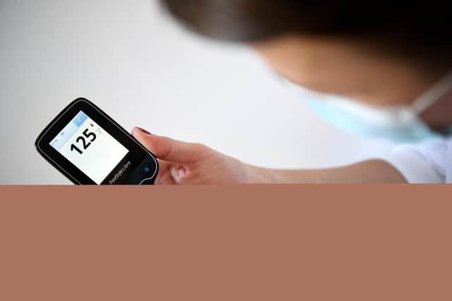 A woman with diabetes measures the concentration of sugar in her blood (Picture: Franck Fife/AFP via Getty Images)