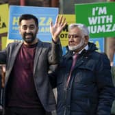 Humza Yousaf waves as he stands with his mother Shaaista and father Muzaffar during an event at Pollockshields Burgh Hall. Picture: Jeff J Mitchell/Getty Images