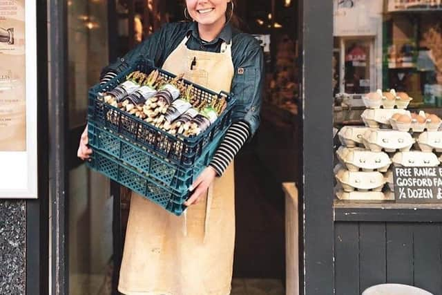 Shop owner with box of Lunan Bay asparagus