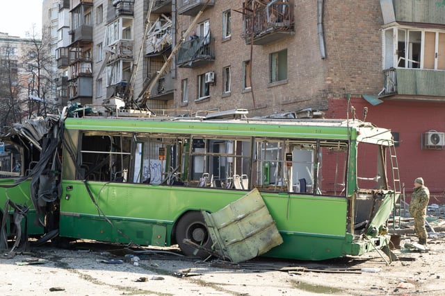 A destroyed trolley bus, hit by pieces of a Russian missile intercepted was part of the barricade. 

Photojournalist Bennett Murray