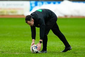 Referee Don Robertson calls the Dundee v Rangers match off during a secondary pitch inspection. (Photo by Ewan Bootman / SNS Group)