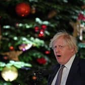 Prime Minister Boris Johnson stands in front of the Downing Street Christmas tree as he makes a speech. Picture: Justin Tallis/AFP via Getty Images
