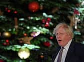 Prime Minister Boris Johnson stands in front of the Downing Street Christmas tree as he makes a speech. Picture: Justin Tallis/AFP via Getty Images