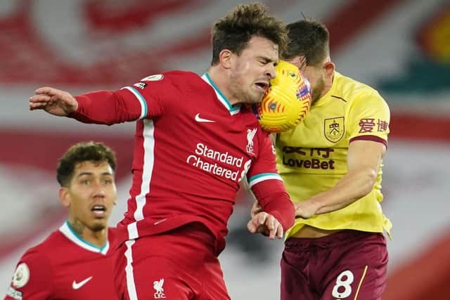 Liverpool's Swiss midfielder Xherdan Shaqiri (L) heads the ball against Burnley's English midfielder Josh Brownhill (R) during the English Premier League football match between Liverpool and Burnley at Anfield in Liverpool, north west England on January 21, 2021. (Photo by Jon Super / POOL / AFP)