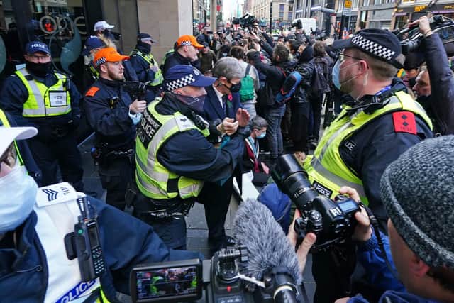 Police arrest an Extinction Rebellion protester outside SSE Renewables in Glasgow during the Cop26 summit. Photo credit: Jane Barlow/PA Wire