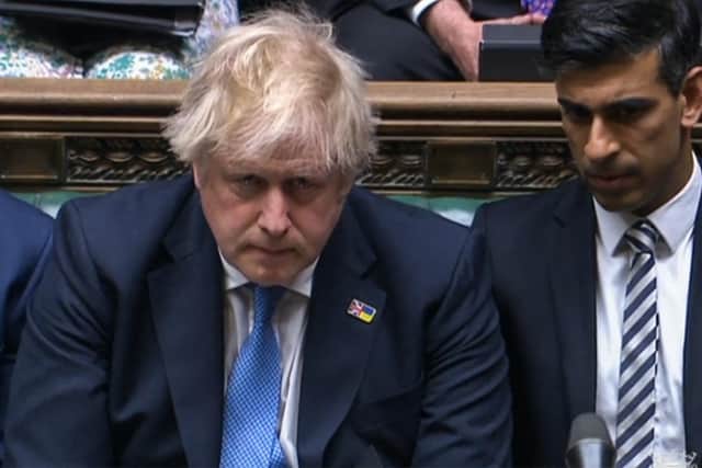 Prime Minister Boris Johnson reacts after apologising to MPs